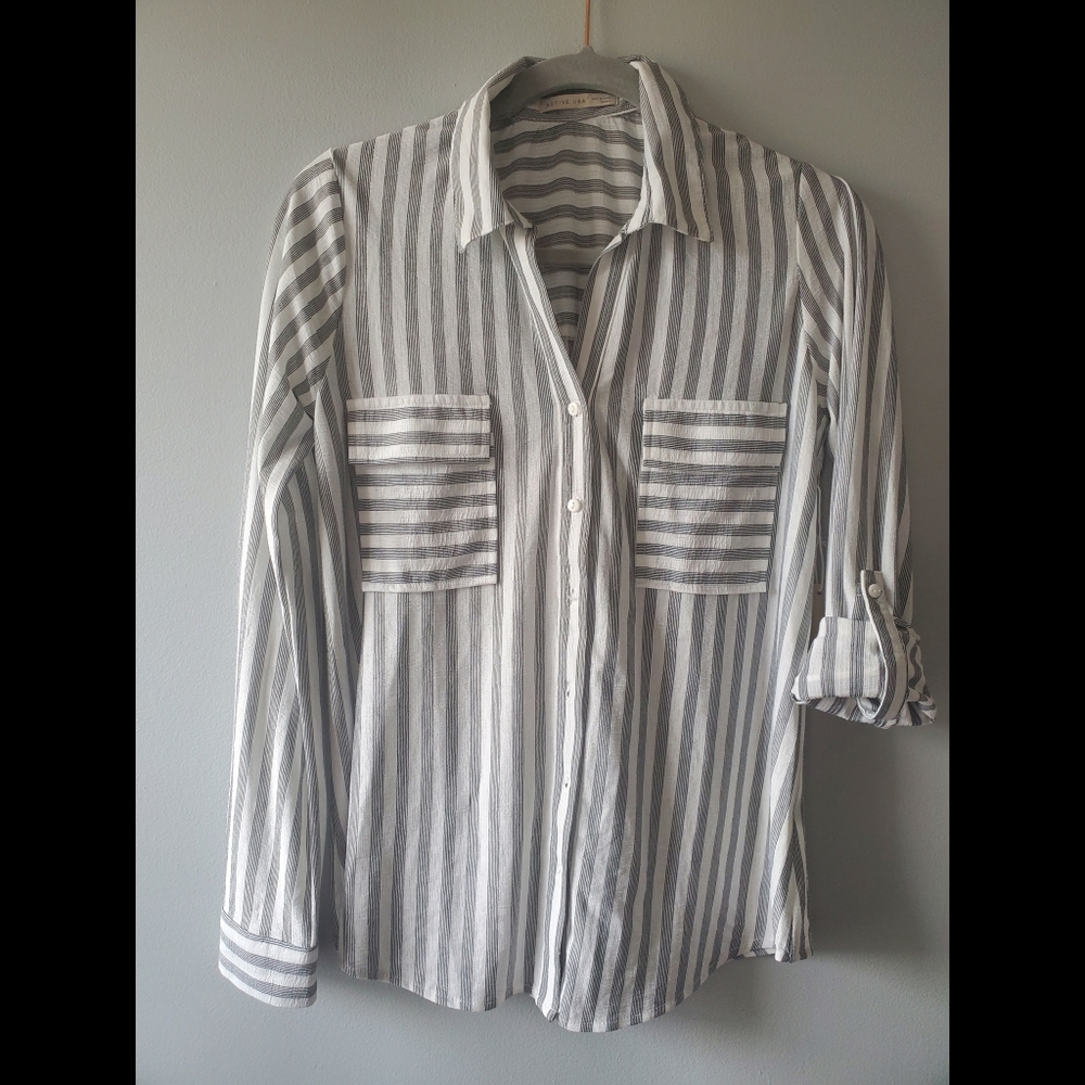 Black and white women's striped roll up sleeve, button down blouse shirt.
